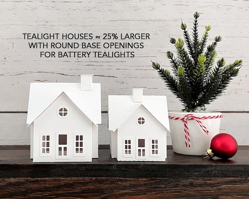 Puede incluir: Dos casas de papel blanco con aberturas redondas en la base, dise&ntilde;adas para velas de t&eacute; a pilas. El texto de la imagen dice "Tealight Houses ~ 25% Larger with Round Base Openings for Battery Tealights".