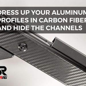 May include: Close-up of a carbon fiber panel with the text "DRESS UP YOUR ALUMINUM PROFILES IN CARBON FIBER AND HIDE THE CHANNELS". The panel is black with a textured pattern and a red stripe.
