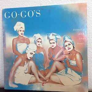 May include: Album cover for the Go-Go's album "Beauty and the Beat". The cover features five women wearing white towels, with the band's name and album title in large, bold letters.