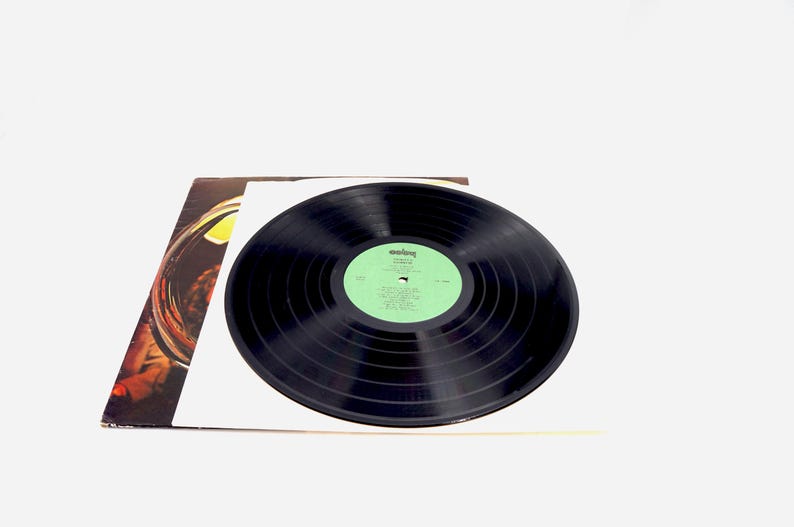May include: A black vinyl record with a green label. The label has the text "Rolling Stones" and the album title "Some Girls".