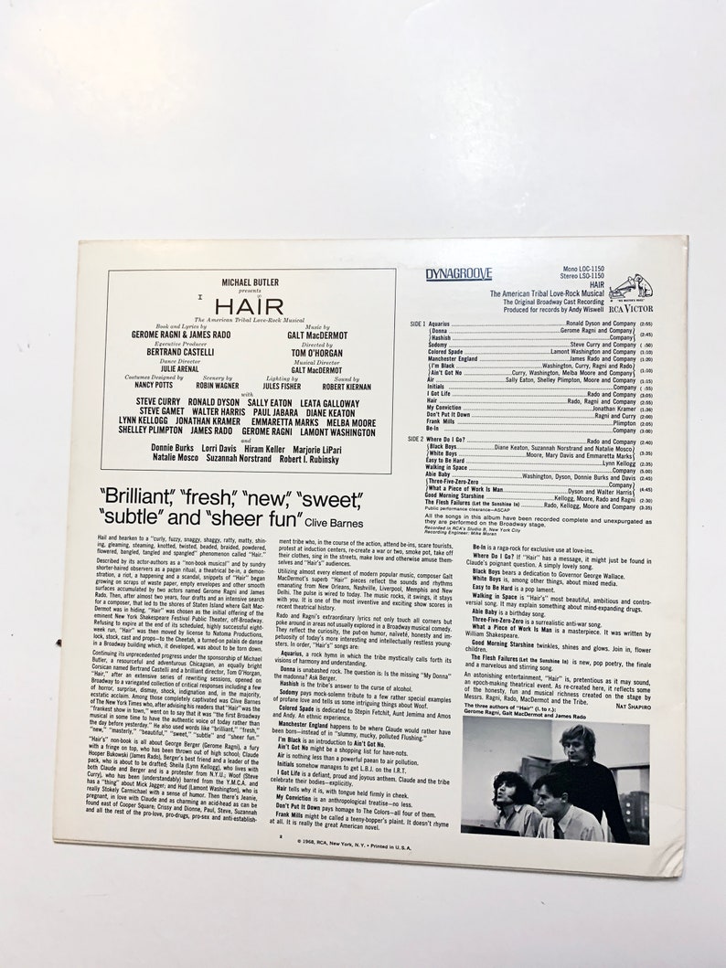 May include: A vintage vinyl record cover for the musical "Hair" featuring the original Broadway cast. The cover is a vibrant yellow with black text and a photo of three men. The text includes the title "Hair", the names of the cast members, and the song titles from the album.