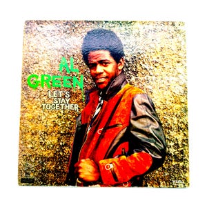 May include: Album cover featuring Al Green with the text "AL GREEN" in green and "LET'S STAY TOGETHER" in white. Green is wearing a red and black jacket. The background has a textured, mottled appearance.