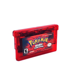 May include: Red Game Boy Advance game cartridge with a red label featuring the Pokemon logo and the text "Pokemon Ruby Version". The label also includes the ESRB rating "E for Everyone" and the Nintendo logo.