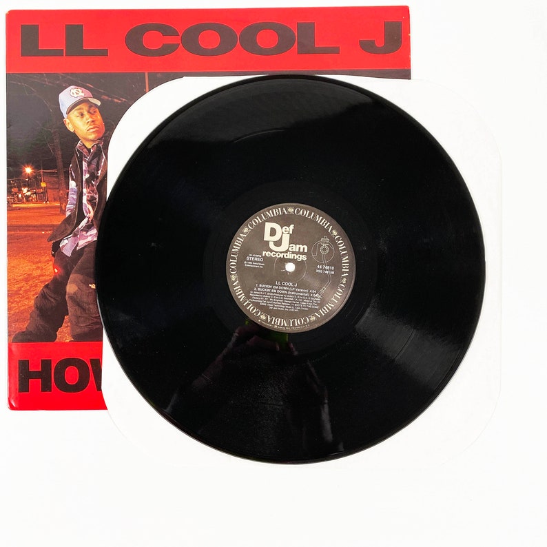 May include: A black vinyl record with a white label featuring the text "LL Cool J" and the Def Jam Recordings logo. The record is on a white surface.