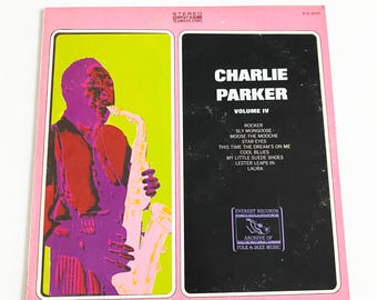 May include: Vintage vinyl record album cover for Charlie Parker, Volume IV. The album cover features a pink border, a pop art style image of Parker playing the saxophone, and a black panel with the album title and track list.