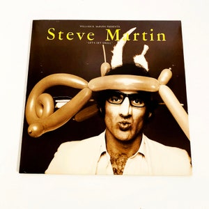 May include: A vintage record album cover featuring Steve Martin with a balloon animal hat. The album title is "Let's Get Small" and the text "William E. McEuen Presents" is at the top of the cover.