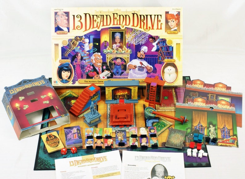 May include: A board game called "13 Dead End Drive" with a colorful box featuring illustrations of characters and a mansion. The game includes a game board, cards, and game pieces.