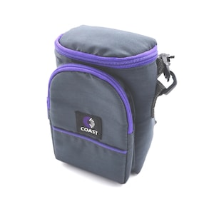 May include: A gray camera bag with a purple zipper and trim. The bag has a small pocket on the front with the word "COAST" printed on it.