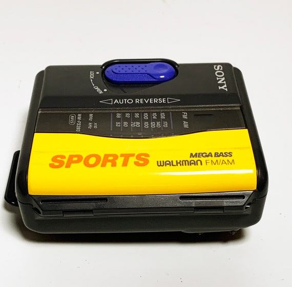 Using a 90s Yellow Sony Walkman Cassette, Stock Video