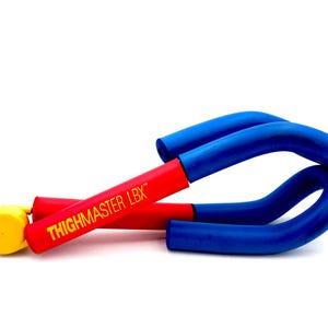 May include: A Thighmaster LBX exercise device. The device is red and blue with yellow accents. The text "THIGHMASTER LBX" is printed in yellow on the red section of the device. The device is designed for leg workouts.