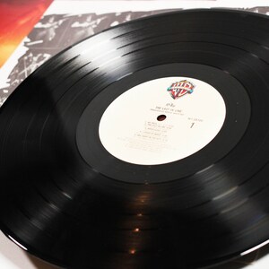 May include: A black vinyl record with a white label. The label has the text "The Last In Line" and the artist's name "Ozzy" printed on it. The record is part of a vinyl record collection.