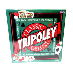 May include: A green box with the words "Classic Tripoley Deluxe" in red and white. The box features the text "The Original Game of Michigan Rummy, Hearts & Poker" and images of playing cards.
