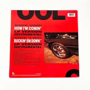 May include: The back cover of a vinyl record with a red background and black text. The record is titled "Cool" and features the songs "How I'm Comin'" and "Buckin' Em Down". The record is by Def Jam Columbia and features a car on the cover.