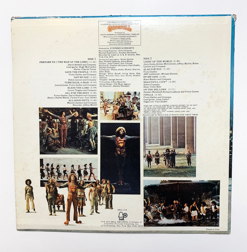 May include: The back cover of a vinyl record for the musical "Godspell". The cover features a collage of images from the musical, including a man in a red and yellow costume, a group of people singing, and a cityscape. The text on the cover includes the title of the musical, the composer's name, and the names of the actors and actresses who appear in the musical.