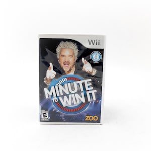 May include: A Wii video game case for "Minute to Win It" featuring a man with spiky, frosted hair. The game case has a blue and red circular design with the game title. The game is rated "E" for Everyone.