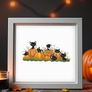 May include: A framed cross-stitch depicting black cats on orange pumpkins. The image is set against a backdrop of candles and carved pumpkins, creating a Halloween theme. The cats have green eyes.