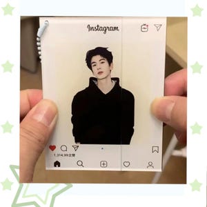 May include: A clear acrylic Instagram-themed card featuring a portrait of a person in a black hoodie. The card includes the Instagram logo and interface elements, such as like, comment, and share icons. The text "Instagram" is visible at the top.