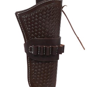 May include: A brown leather gun holster with a basket weave pattern and white stitching. The holster has a loop for a belt and a band with bullet loops. A leather strap hangs from the side.
