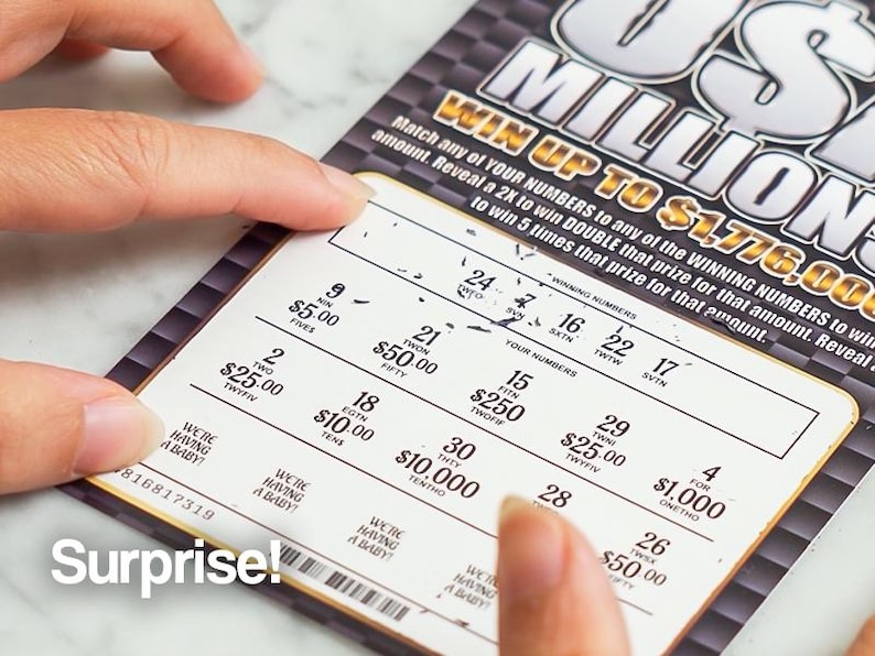May include: A lottery ticket with the text "US MILLIONS" and the potential to win up to $1,776,000. The ticket is being scratched to reveal the winning numbers. The word "Surprise!" is printed on the bottom left.