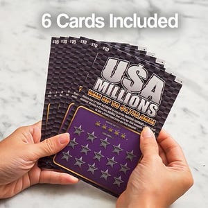 May include: A hand holding a stack of six USA Millions scratch-off lottery tickets. Each ticket is black and purple with the text "USA MILLIONS" and "WIN UP TO $1,776,000!" The tickets are $10 each.