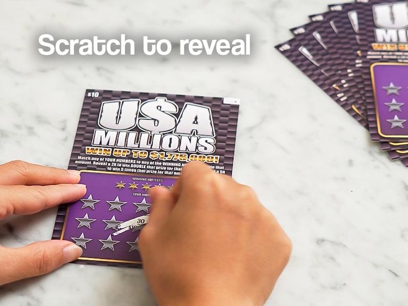 May include: A person scratching a "USA Millions" lottery ticket. The ticket has a purple background with silver stars and the text "Scratch to reveal". The text "WIN UP TO $1,779,000!" is also visible. Other tickets are in the background.