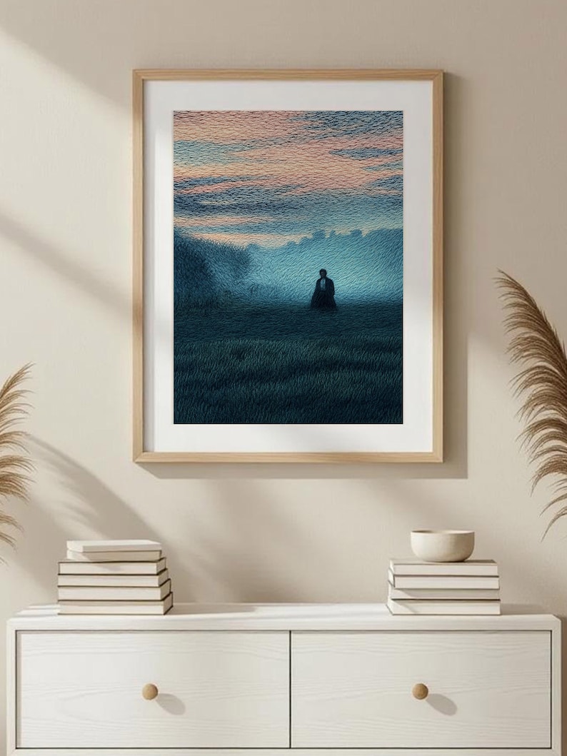 May include: Framed art print depicting a solitary figure in a field at dusk. The artwork features a color palette of blues, greens, and pinks, with a textured, painterly style. The frame is a light wood tone.