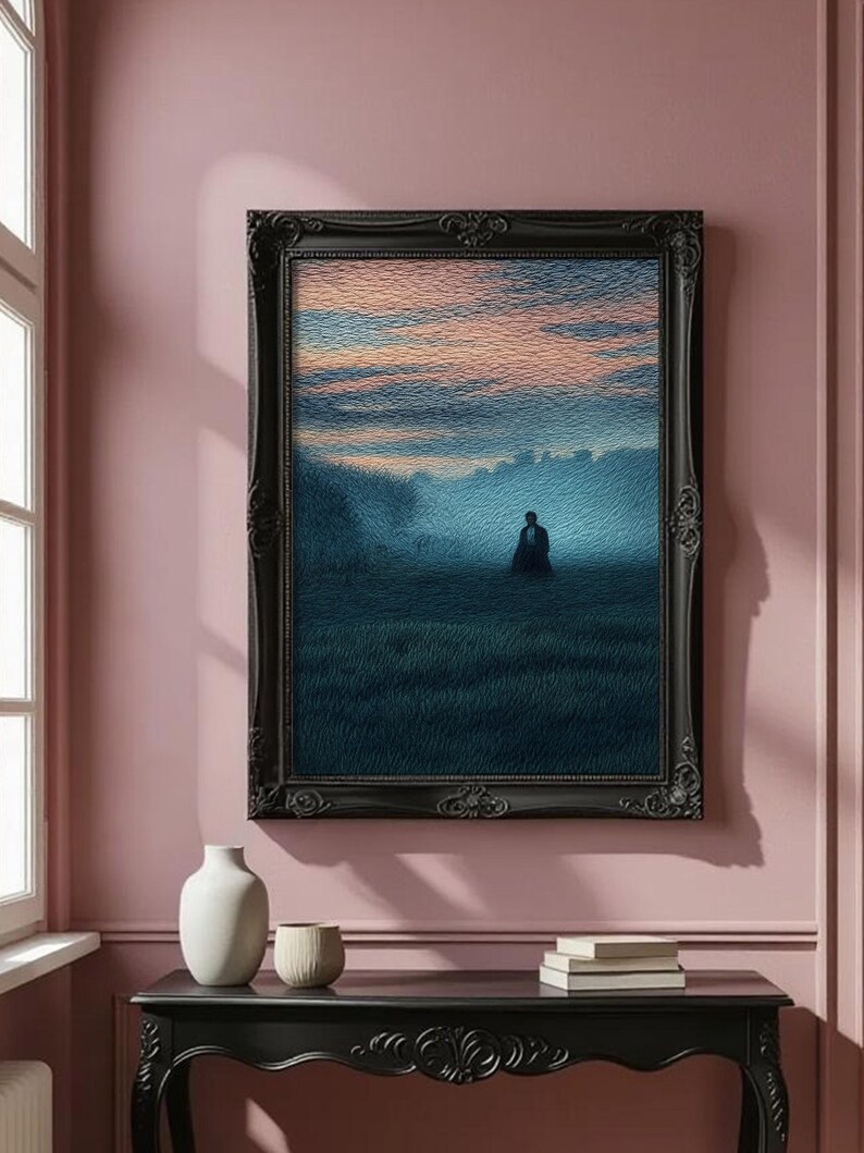 May include: A framed artwork depicts a solitary figure in a field under a dusky sky. The painting, in shades of blue, green, and orange, is set within a black ornate frame. The artwork hangs on a pink wall above a black table with decorative carvings.