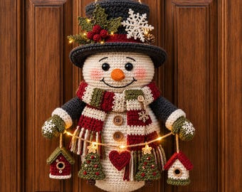 May include: A crocheted snowman wall hanging wearing a dark gray top hat decorated with holly, berries, and a white snowflake. The snowman features a striped scarf, three wooden buttons, and a string of warm LED lights holding two small birdhouses.
