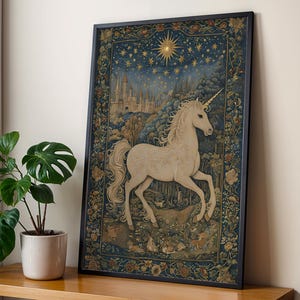 May include: Framed art print depicting a white unicorn with a golden horn, set against a starry night sky, a castle, and a forest. The artwork is framed in a black border and has a floral border.