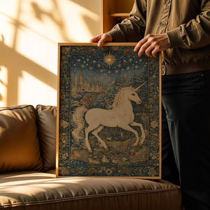 May include: A framed tapestry featuring a white unicorn with a golden horn, set against a night sky with stars and a castle. The artwork has a detailed, vintage style with a gold frame, creating a whimsical and enchanting scene.