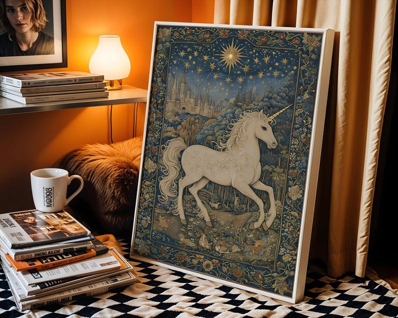May include: A framed tapestry featuring a white unicorn in a forest setting under a starry night sky. The artwork has a detailed, vintage style with a white frame. The color palette includes blues, greens, and gold.