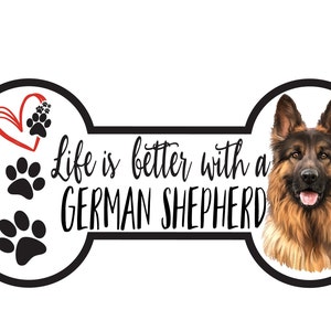 May include: A white bone-shaped sign with black paw prints and a red heart. The sign reads "Life is better with a German Shepherd". A German Shepherd dog is pictured on the right side of the sign.