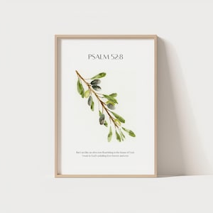 Könnte beinhalten: Ein gerahmter Druck mit einer Aquarellillustration eines Olivenzweigs mit grünen Blättern und Oliven. Der Text "PSALM 52:8" steht oben, darunter ein Bibelvers. Der Rahmen hat eine helle Holzfarbe.