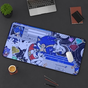 May include: A rectangular desk mat featuring a blue Sonic the Hedgehog character graphic with a distressed aesthetic. The design includes a media player interface, floating colorful gems, and a pop-up window with the text You're too slow!