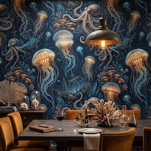 May include: A dining room featuring wallpaper with a dark blue background, jellyfish, octopuses, and shipwrecks. The room includes a wooden table with orange velvet chairs, a sextant, a coral sculpture, a wine glass, and a hanging metal pendant light.