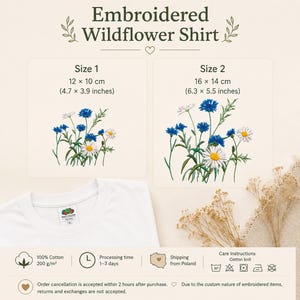 May include: A white t-shirt featuring an embroidered wildflower design. The image displays two size options: Size 1 at 4.7 x 3.9 inches and Size 2 at 6.3 x 5.5 inches. The embroidery depicts blue cornflowers and white daisies with green stems.