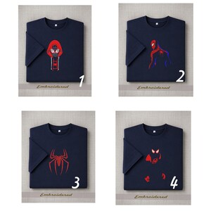 May include: Four navy blue t-shirts with different Spider-Man designs. Each shirt features a unique red and white graphic of the superhero. The word "Embroidered" is printed below each shirt, with a number from 1 to 4.