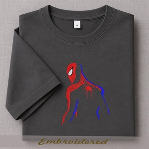 May include: Dark gray t-shirt featuring a red and blue embroidered Spider-Man design. The design shows the character's back and head. The shirt has a crew neck and short sleeves. The word "Embroidered" is at the bottom.