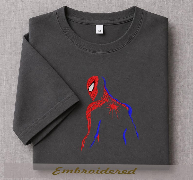 May include: Dark gray t-shirt featuring a red and blue embroidered Spider-Man design. The design shows the character's back and head. The shirt has a crew neck and short sleeves. The word "Embroidered" is at the bottom.
