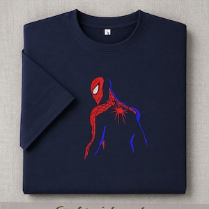 May include: Navy blue t-shirt featuring an embroidered Spider-Man design. The graphic depicts the superhero in red and blue, with the word "Embroidered" at the bottom. The shirt has a classic crew neck and short sleeves.