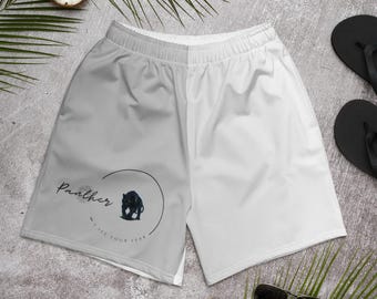 May include: Athletic shorts with a gray and white color block design. The left leg features a black panther graphic inside a circle, with the text "Panther" and "I SEE YOUR FEAR". The shorts have a drawstring waistband.