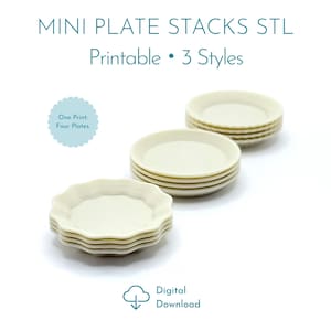 May include: Mini plate stacks STL printable 3 styles digital download. One print four plates. Two stacks of off-white miniature plates are displayed. One stack features plates with scalloped edges, while the other stack features plates with smooth, rounded edges.