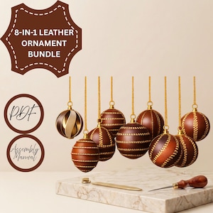 May include: An 8-in-1 leather ornament bundle featuring eight spherical brown leather ornaments with gold stitching and gold hanging cords. The image includes text reading 8-IN-1 LEATHER ORNAMENT BUNDLE, PDF, and Assembly Manual, with a metal tool.