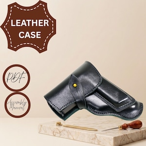 May include: A black leather case with a flap closure secured by a single yellow stud. The image includes text that reads LEATHER CASE, PDF, and Assembly Manual. A small metal tool and a wooden-handled awl are positioned near the leather item.
