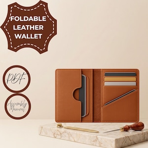 May include: A tan foldable leather wallet with multiple card slots, shown open. The image includes text labels reading FOLDABLE LEATHER WALLET, PDF, and Assembly Manual. A metal tool and a wooden-handled awl are placed on the surface below.