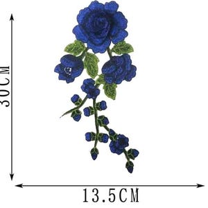 May include: Embroidered floral applique featuring a cluster of deep blue roses with green leaves. The applique measures 11.8 inches in height and 5.3 inches in width. Ideal for embellishing clothing, accessories, or craft projects.
