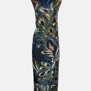 May include: A black, floor-length dress with an intricate peacock feather design. The design features gold, teal, and blue embroidery. The dress is displayed on a black mannequin.