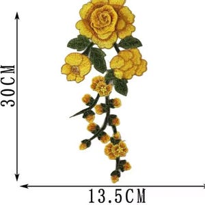 May include: Embroidered yellow rose patch, approximately 11.8 inches tall and 5.3 inches wide. The patch features a large rose at the top, several smaller blooms, and green leaves. The patch is suitable for clothing or craft projects.