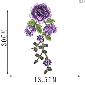 May include: Embroidered purple rose applique, approximately 11.8 inches (30 cm) long and 5.3 inches (13.5 cm) wide. Features a large rose, smaller buds, and green leaves. Ideal for fabric embellishment.