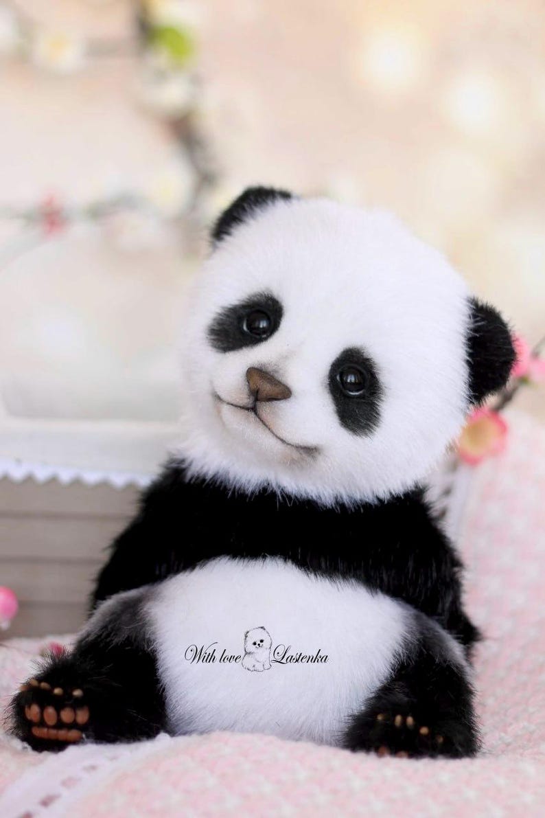 May include: A plush panda bear with black and white fur, black eyes, and a brown nose. The panda is sitting with its legs extended. The text "With love Lasenka" is printed on the panda's belly.